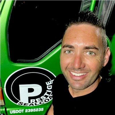 Adam Piché beside a Prestige Sealcoating truck