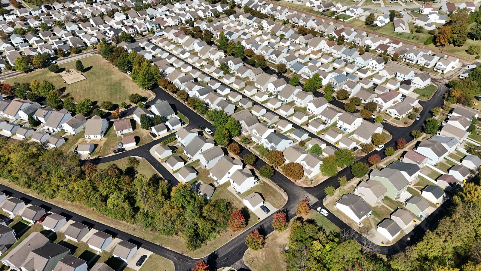 Drone view of a subdivision with freshly paved black streets