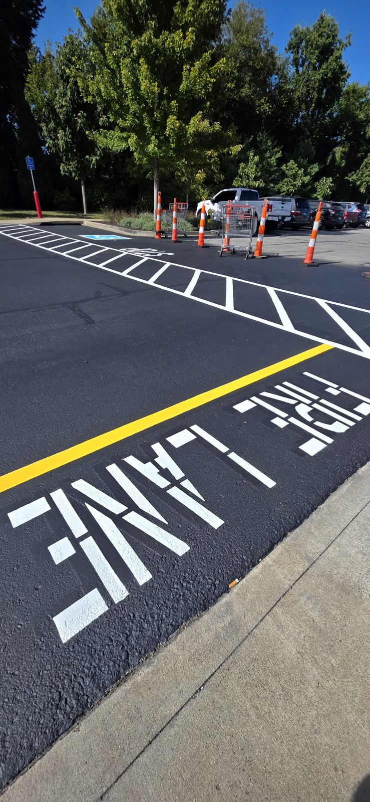 Fresh FIRE LANE stencil and yellow line on new asphalt